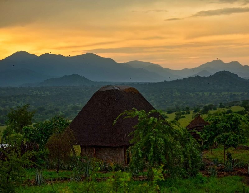 Valley thatched huts below the karamoja mountains at sunset