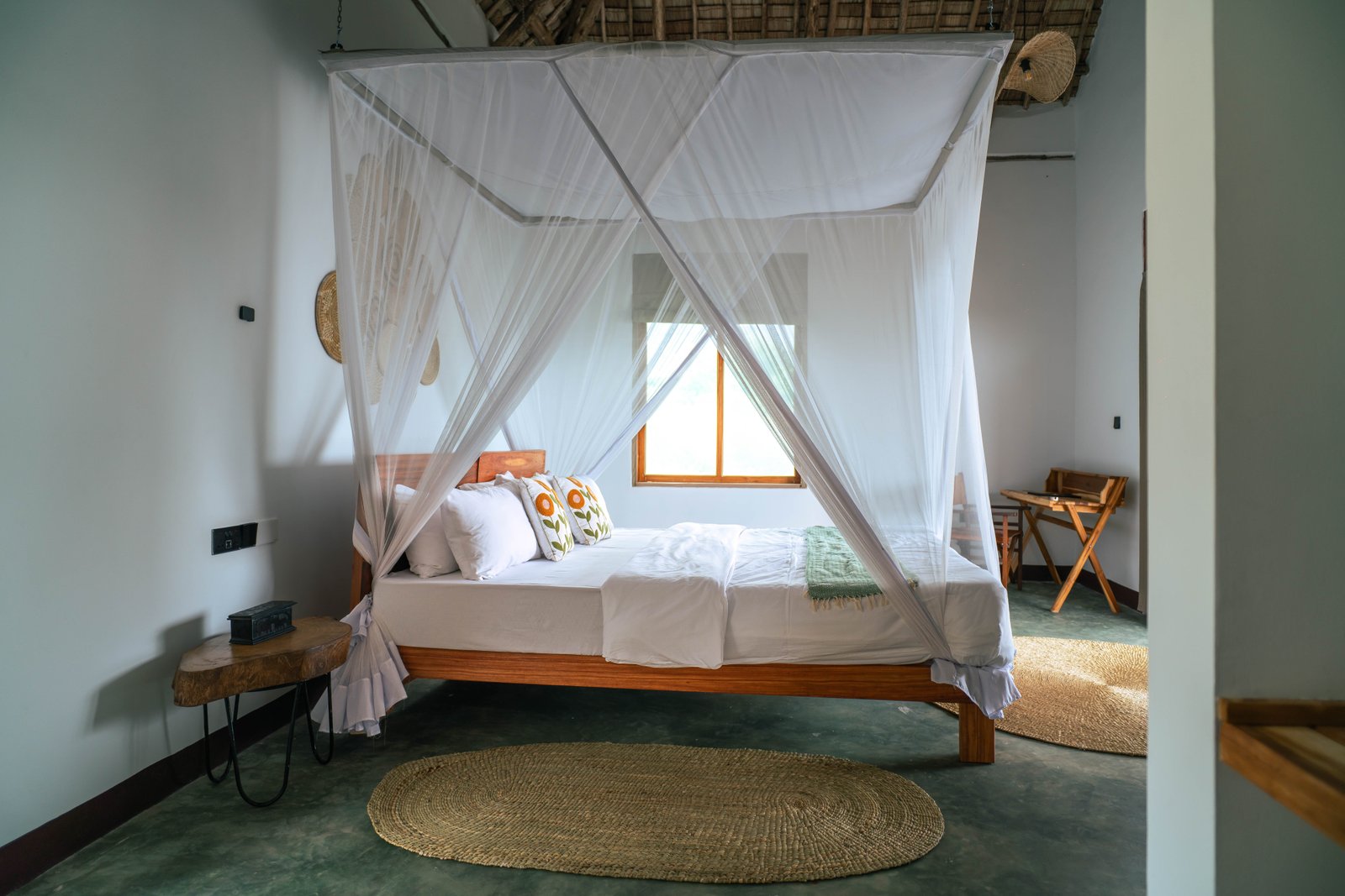 Lodge bedroom with draped mosquito net