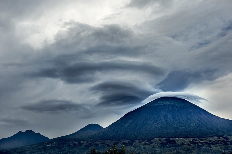 Lenticular cloud cap over volcano in storm light in Volcanoes, Rwanda