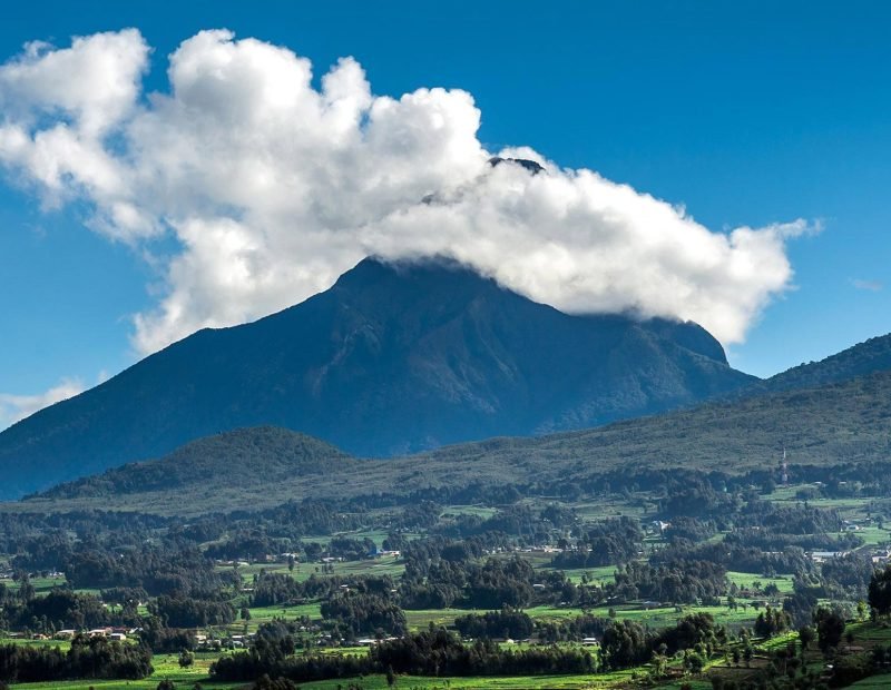 Panorama of volcano above green farmland in Volcanoes, Rwanda